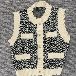 black and white sweater vest, scalloped sleeve and jeweled button